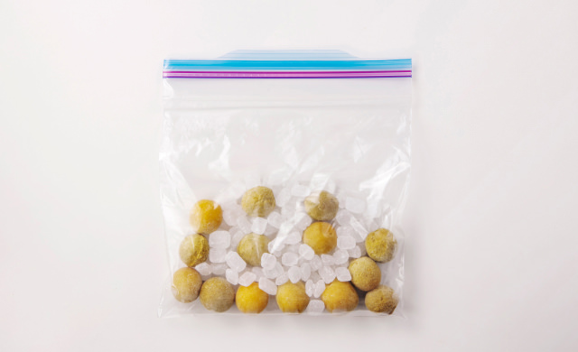 保存袋に入れた冷凍梅と氷砂糖の写真