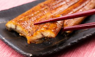 うなぎをひと口サイズに切って箸で持ち上げているところ