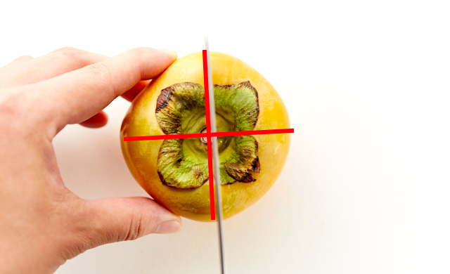 柿に包丁をあてている写真