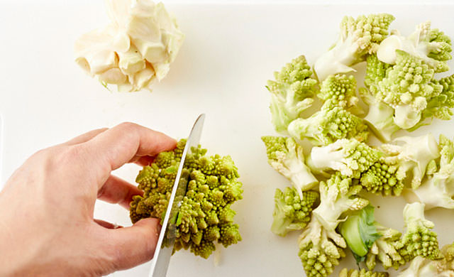 大きな塊のロマネスコを切る写真
