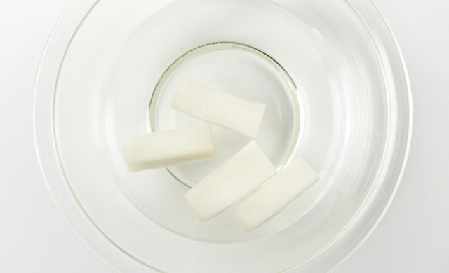 皮をむき短冊にしたうどを酢水につけている写真