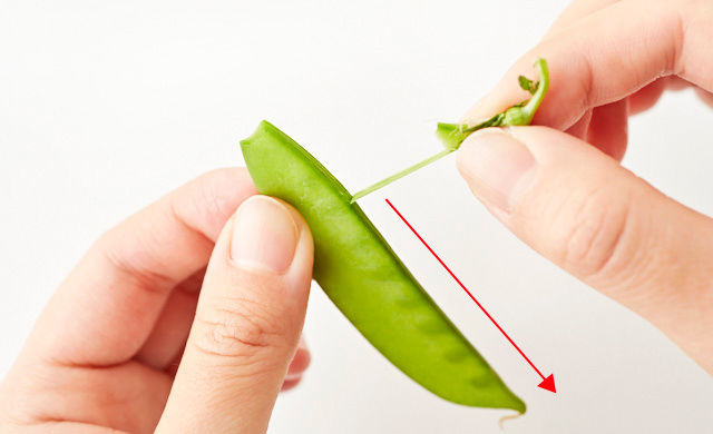 絹さやのヘタと筋をとっている写真