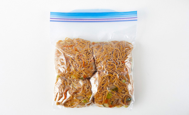焼きそばを冷凍用保存袋に入れている写真