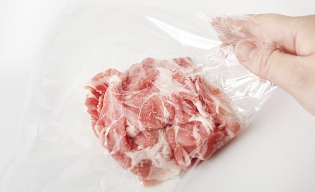豚こま切れ肉をラップで包んでいる写真