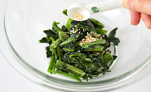 冷凍ほうれん草に顆粒鶏ガラスープの素をかけている写真