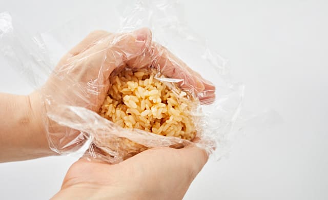 ラップでおにぎりを握っている写真