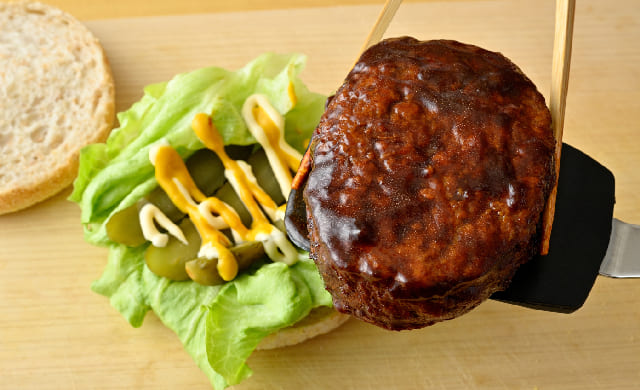 ハンバーグの具材をのせている様子