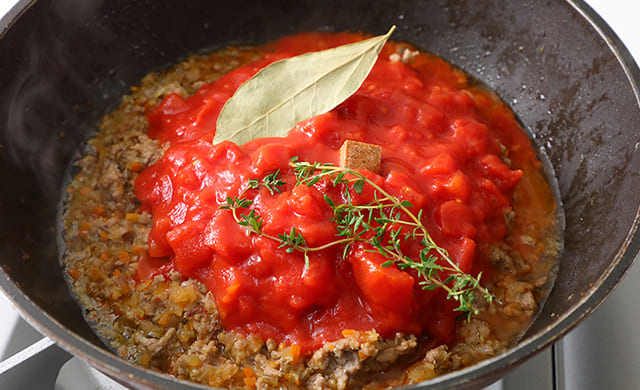 トマト缶を加えている写真